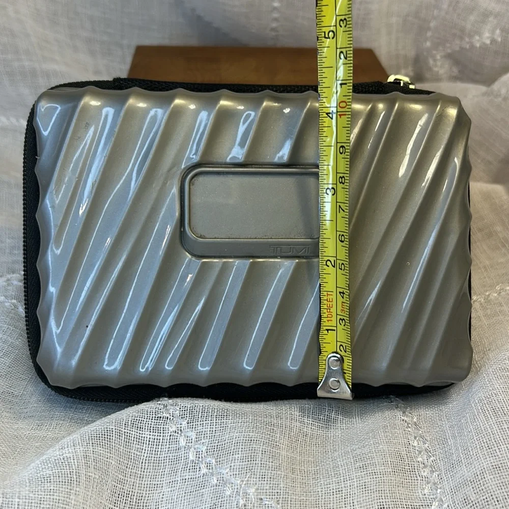 Tumi hard case luggage cosmetic bag filled with goodies for your next trip